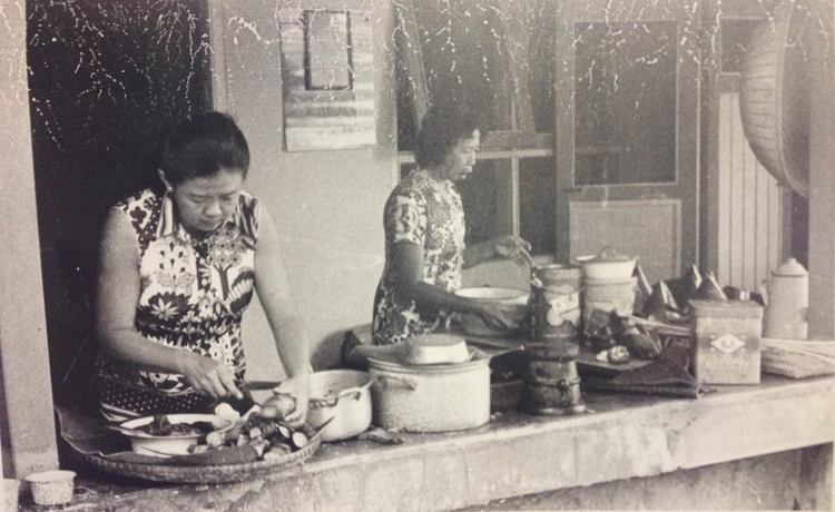 Photograph from May-Li’s parents’ collection. Food is being prepared semi-outdoors, and banana leaves provide a natural wrapping or plate.